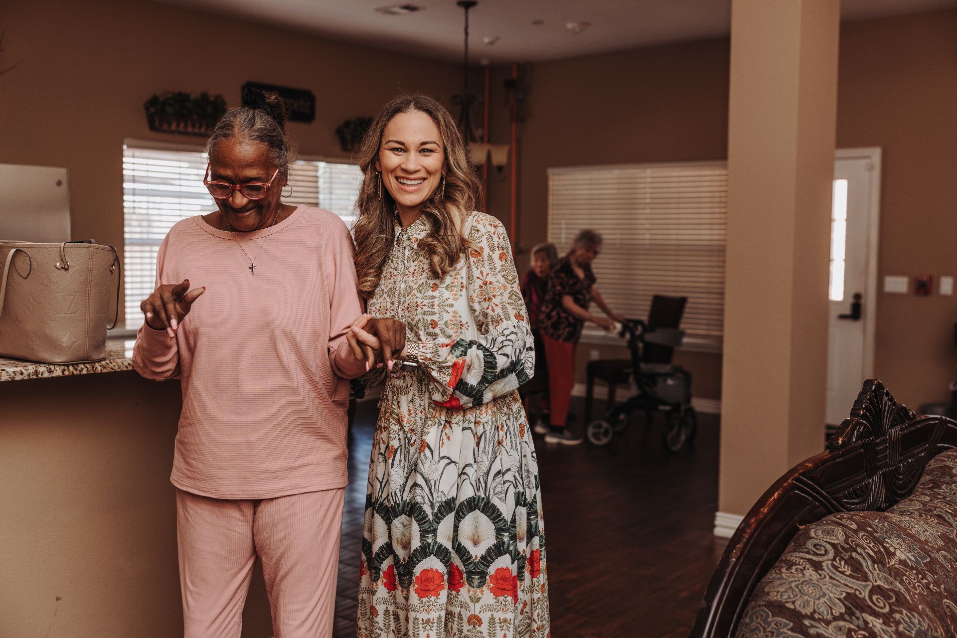 Brittany Williams walking arm in arm with a resident