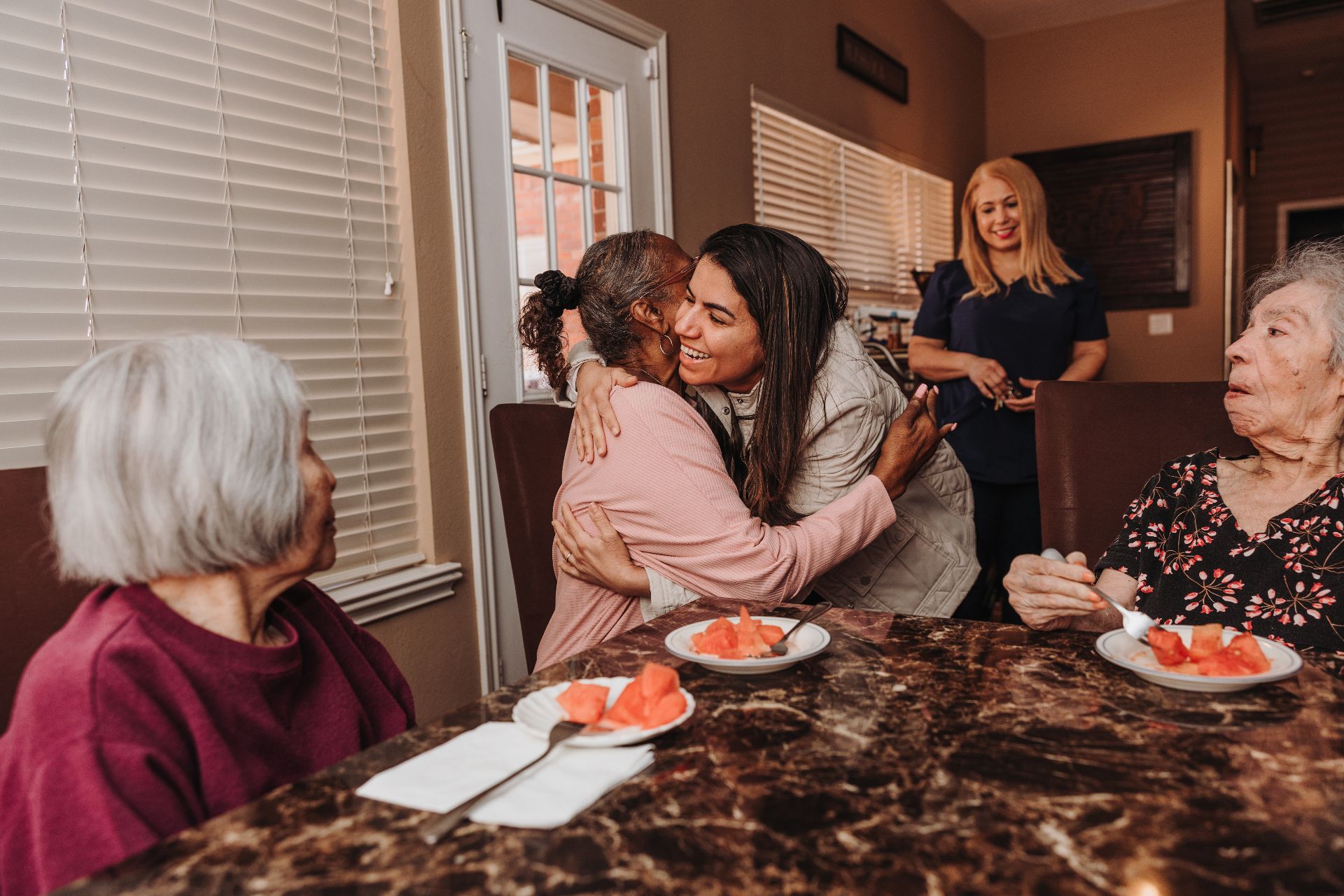 A caregiver embracing a resident